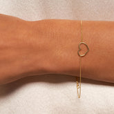 14k Yellow Gold Open Heart Bracelet on hand